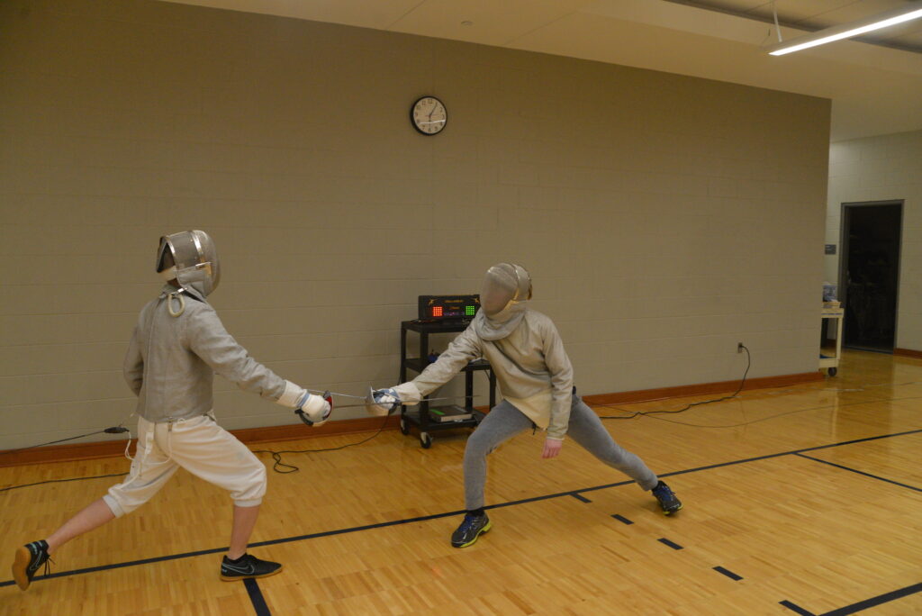 Members of fencing club practicing