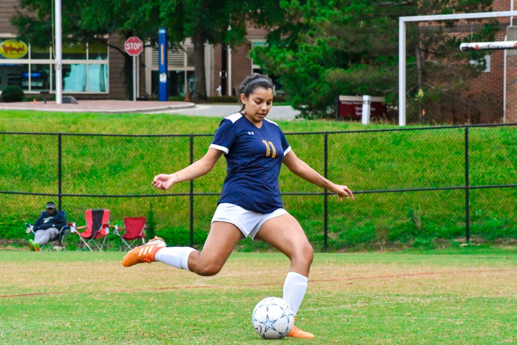 Women's Soccer Club player kicking a soccer ball