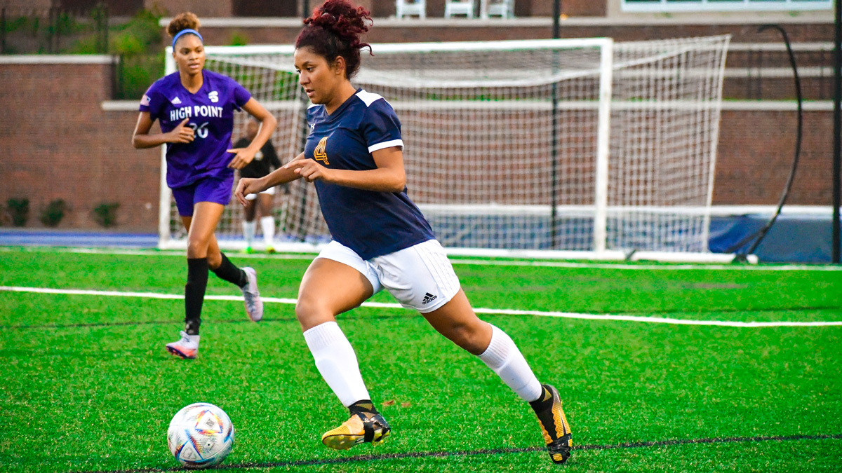 Women's Soccer Club player dribbling a ball