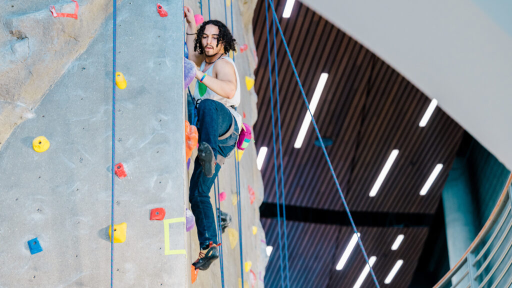 Student Climbing in the indoor climbing wall at the Kaplan Center