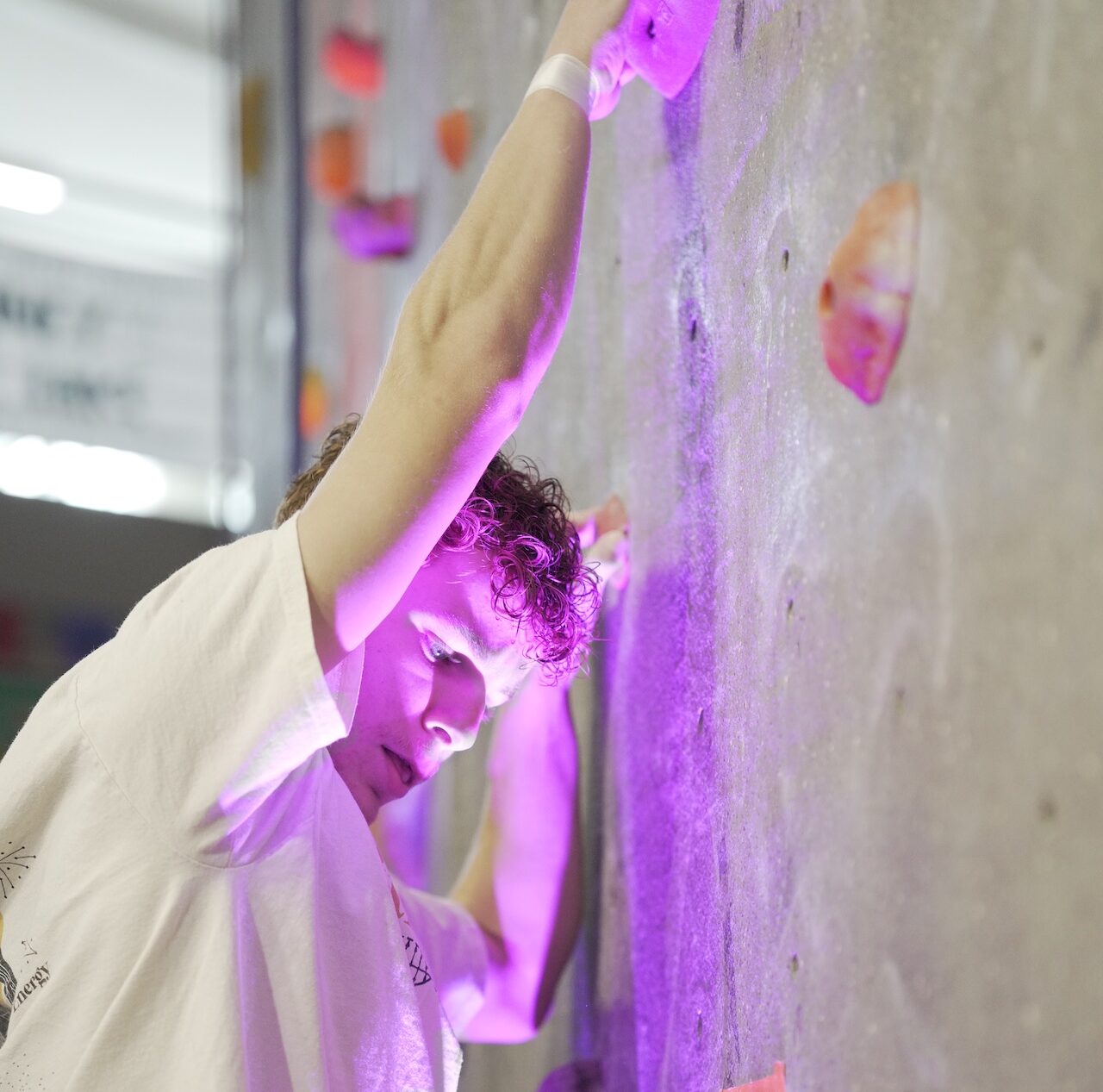 Student climbing the Kaplan Center climbing wall class=img-responsive