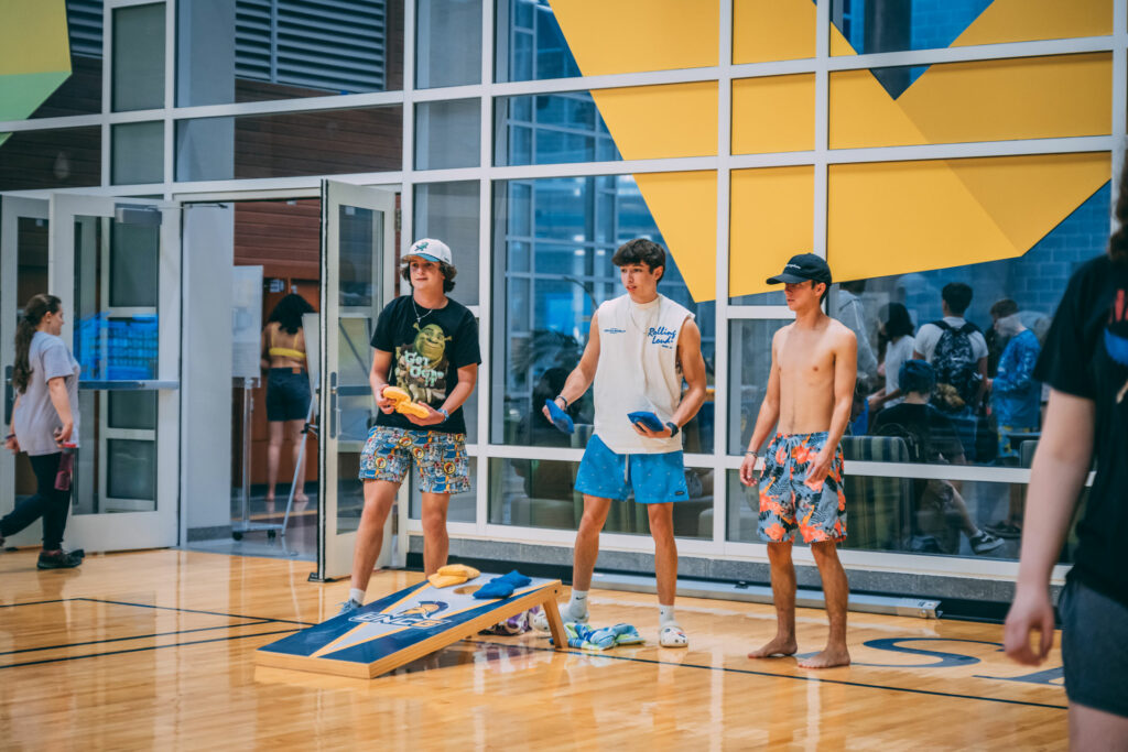 Students playing cornhole in the Kaplan Center