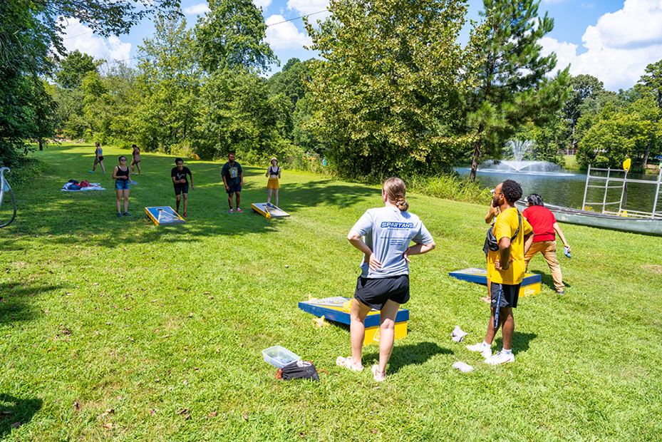 Students playing corn hole at Piney Lake